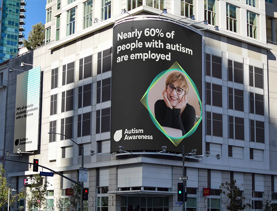 Autism Awareness billboard on building.